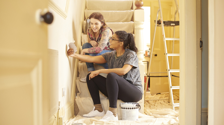 Two women looking at paint colors for a remodel