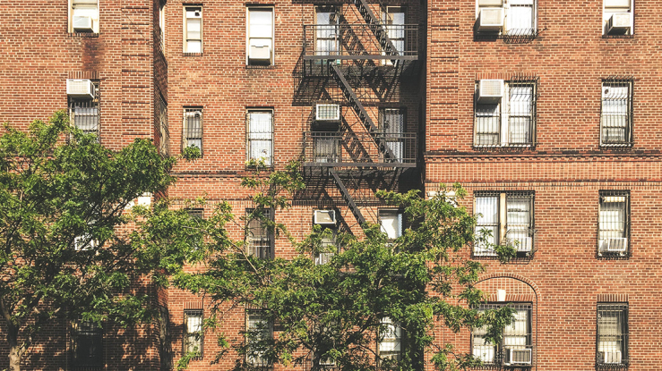 View of apartment building with air conditioners.