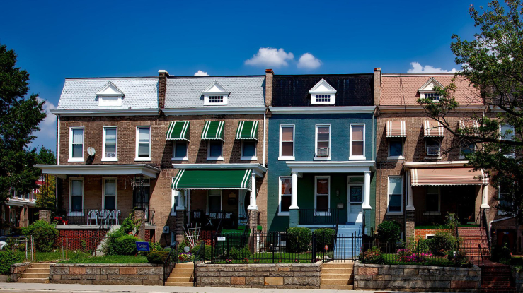 Four rowhouses facing street.