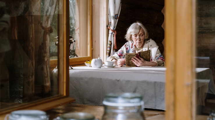 Older woman reading at a table 