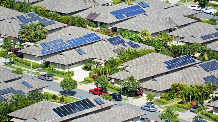 Neighborhood of ranch homes with solar panels.
