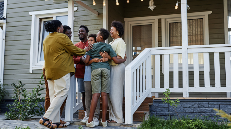 Family assembled on front steps of home.
