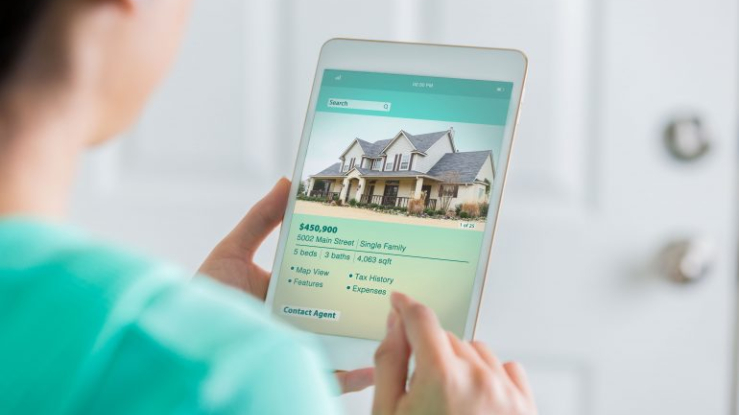 Person looking at housing ad on tablet.