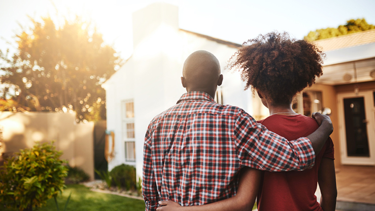 Black couple looking at a house