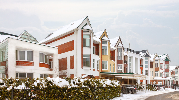 View of snowy apartment complex.