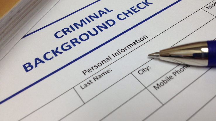Criminal background check document with a pen