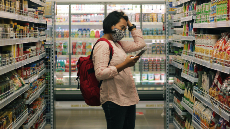 Person standing in grocery store aisle.