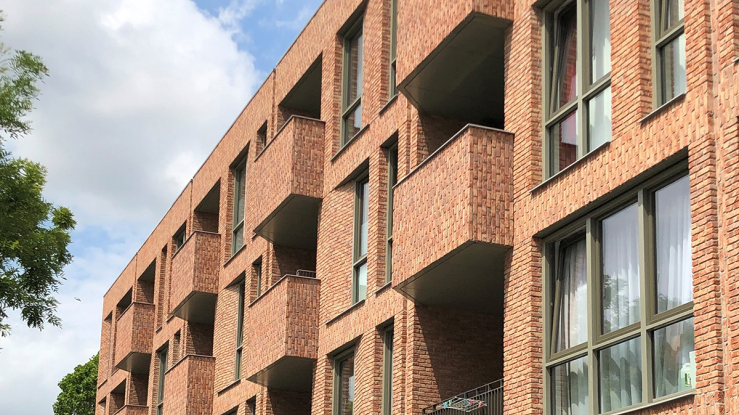 View of brick multifamily housing complex.