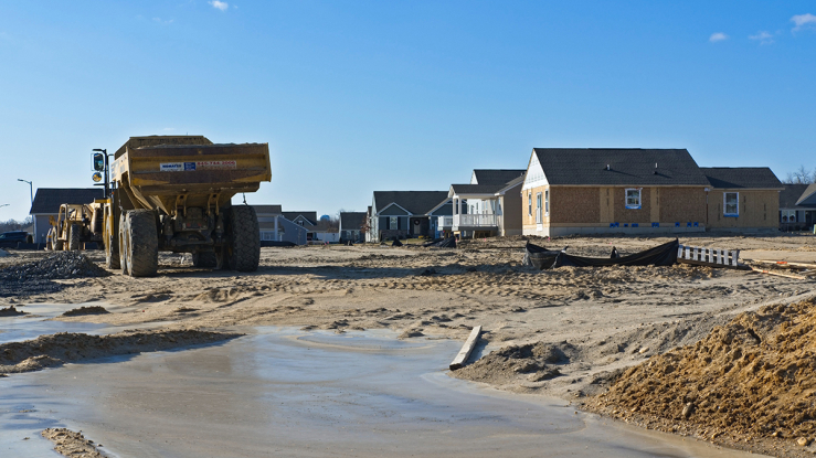 View of lot with half-constructed homes.