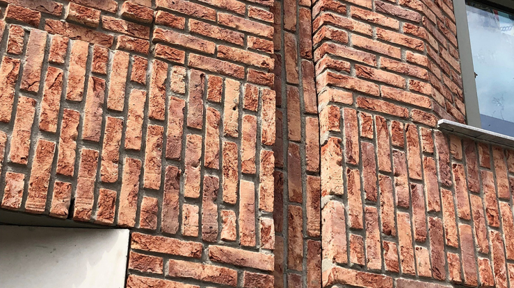 Side of brick building with window.