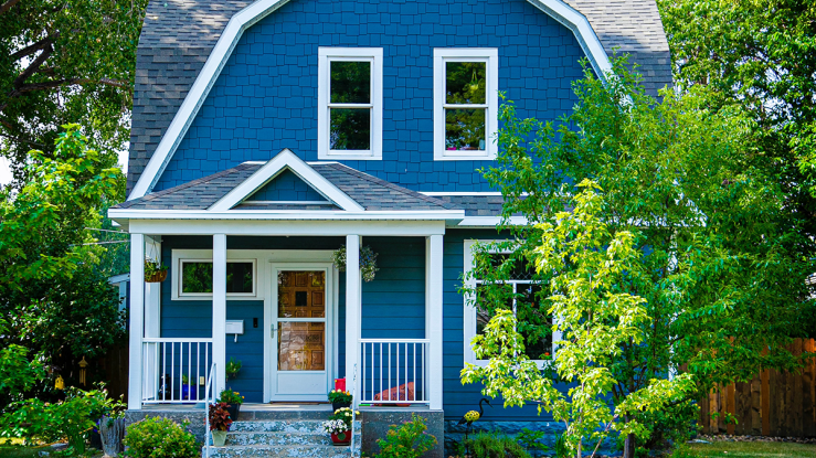 View of a small home with yard.