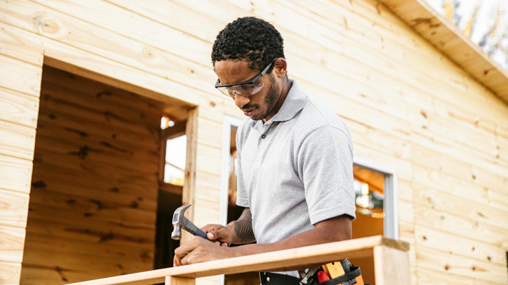 Man using a hammer outdoors