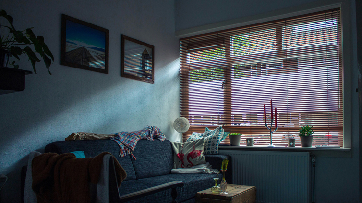 Darkened apartment with shades down.