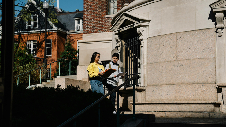 Two students walking on campus