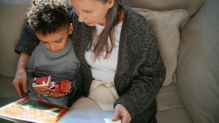 Older woman reading to young child