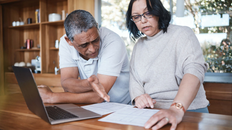 Couple reviewing financial documents.