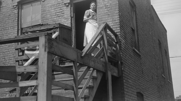 Woman on stairs of a Chicago apartment, 1941.