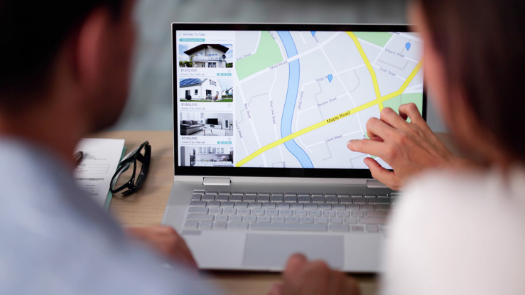 Couple looking at real estate listings online.
