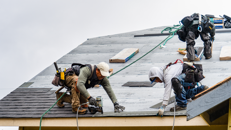 Workers repairing a damaged roof.