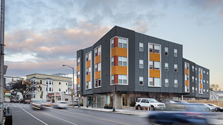 Modern multifamily housing on a city corner.