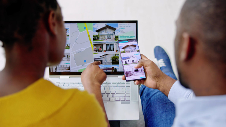 Couple looking at real estate listings online.