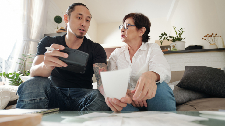 Mother and son discussing bills.