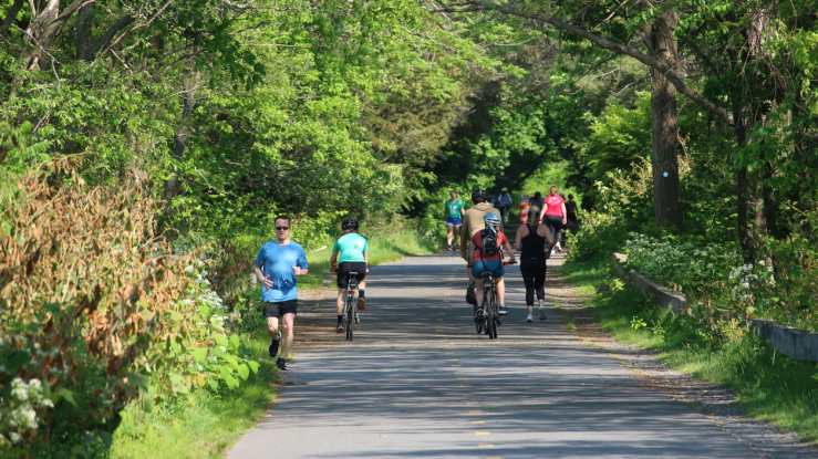 People running and biking on a rail trail.