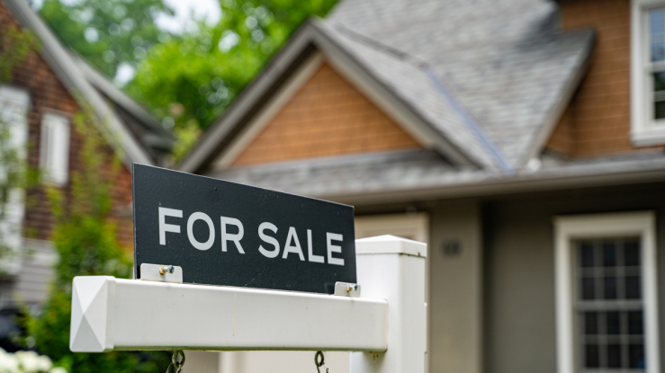 For sale sign in front of a house. 