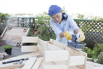 Woman building a wooden bench