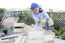 Woman building a wooden bench