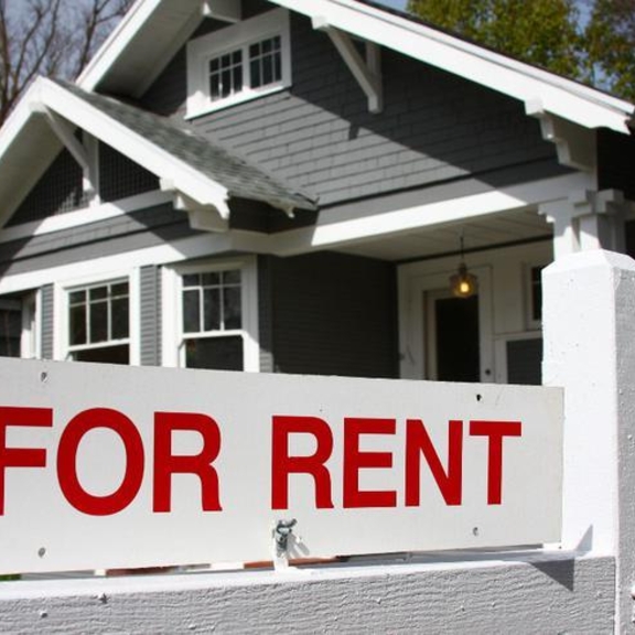 For rent sign outside of single-family home.