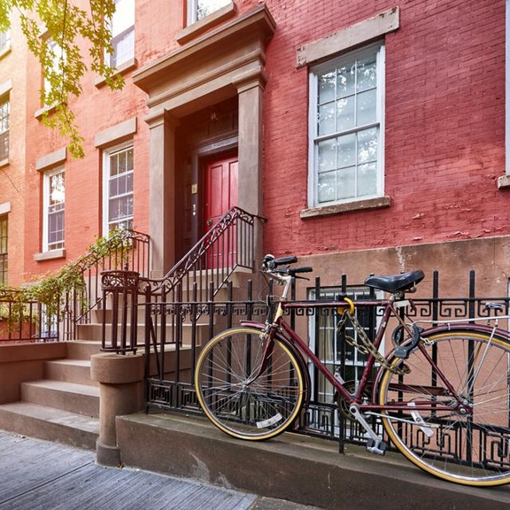 View of a townhouse with fence and steps.