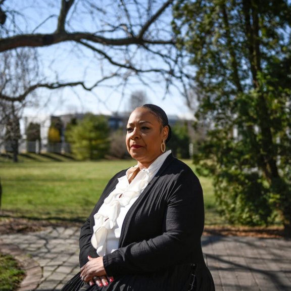 Geriatric social worker Regina Smith standing outside in a park.