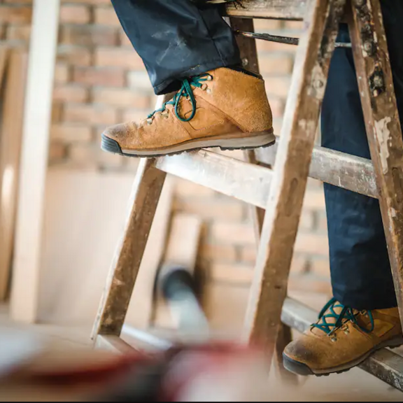 Person climbing wooden step stool.