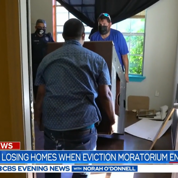 Constables moving belongings out of the home of evicted family.