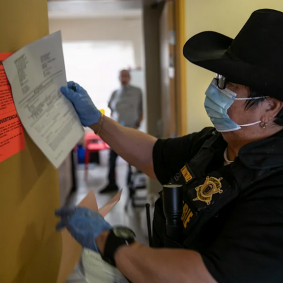 Maricopa County constable Darlene Martinez posts an eviction order for non-payment of rent.