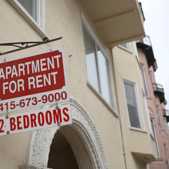 Building with "apartment for rent" sign.