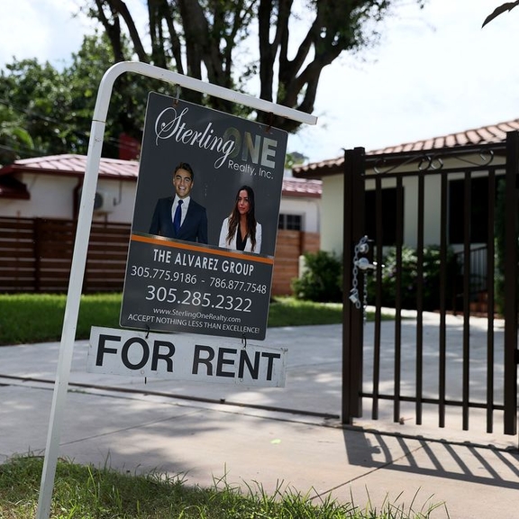 For-rent sign in front of small home.