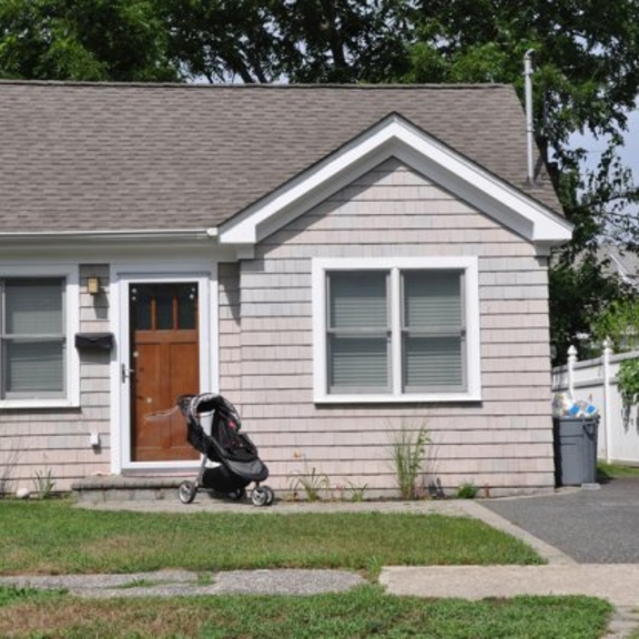 Small home with stroller in front.