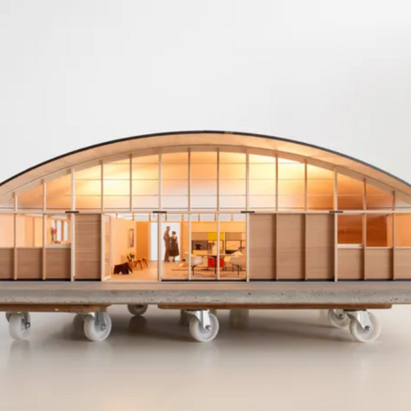 Model of a house on a rolling platform.