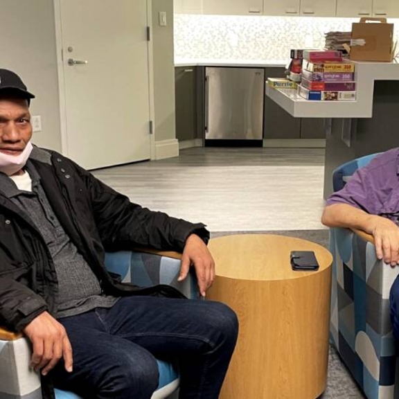 2Life Communities tenants, Darryl Smith and Jules Gordon, meet up at the Brighton campus multi-purpose room to talk and share stories.