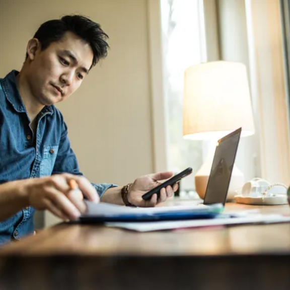 Man reviewing finances at laptop.