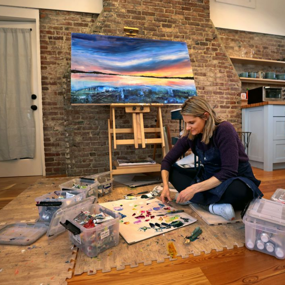 Woman sitting in art studio room.