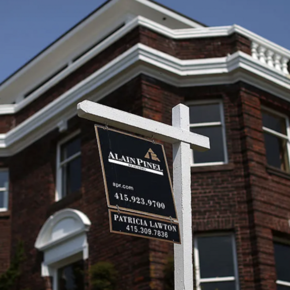 Apartment building with for-rent sign.