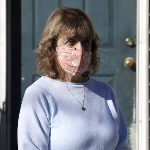 Christine Thompson stands in front of her home in Springfield, Mass. Thompson lived there for more than 50 years, but in January, the 72-year-old widow was forced to move out after the unexpected death of her husband left her in financial ruin, leading to a foreclosure auction. 