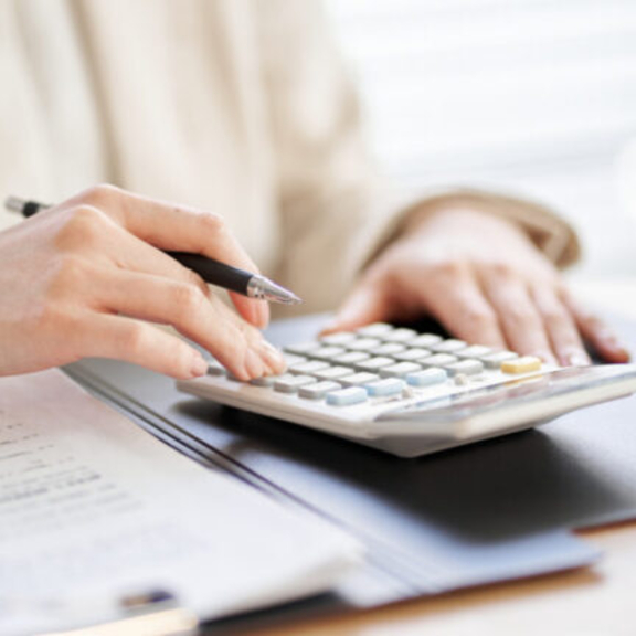 Person typing on calculator.