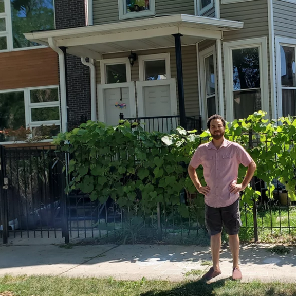 Person standing in front of multifamily house.