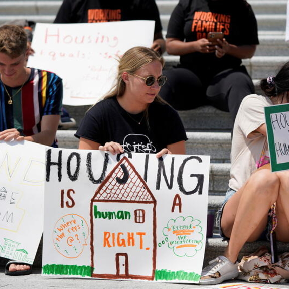 Protestors with "housing is a human right" signs.