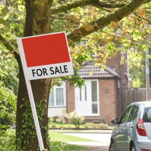 For-sale sign in yard.