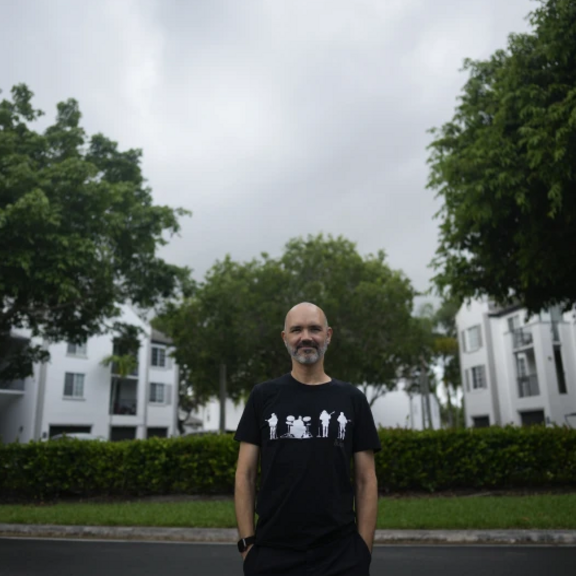 Man standing in front of apartment complex.
